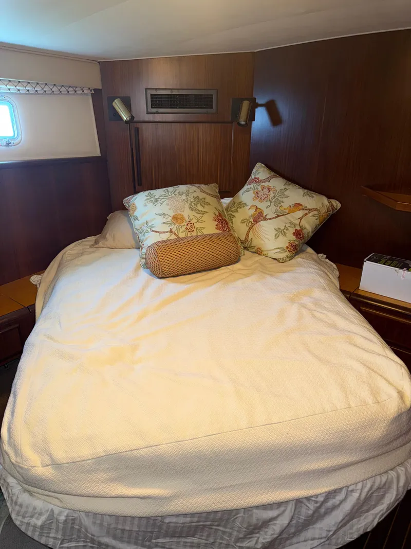 Slide: The Image of Cozy bedroom in 1990 Hatteras 45 Convertible yacht with floral pillows. - 16