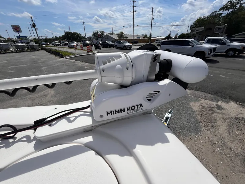 Slide: The Image of Minn Kota motor on 2023 Tidewater 2700 Carolina Bay boat, parked outdoors. - 13
