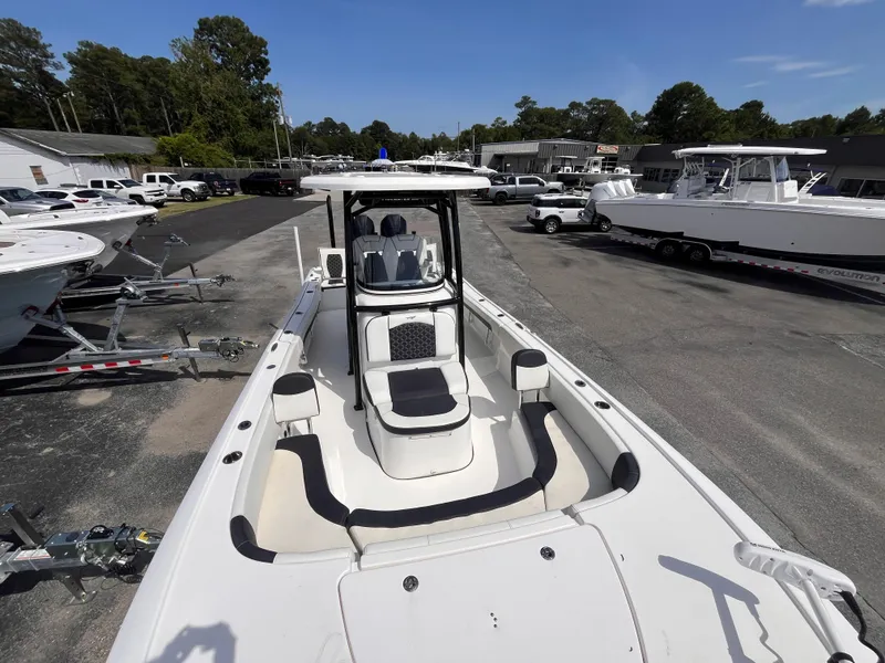 Slide: The Image of 2023 Tidewater 2700 Carolina Bay boat displayed in a marina with other boats. - 14