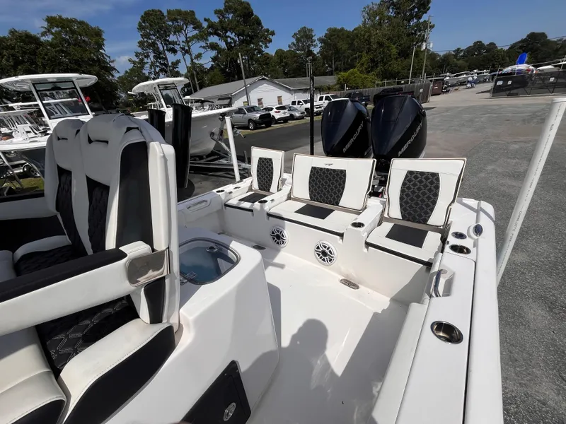 Slide: The Image of 2023 Tidewater 2700 Carolina Bay boat interior with seating and dual engines. - 17