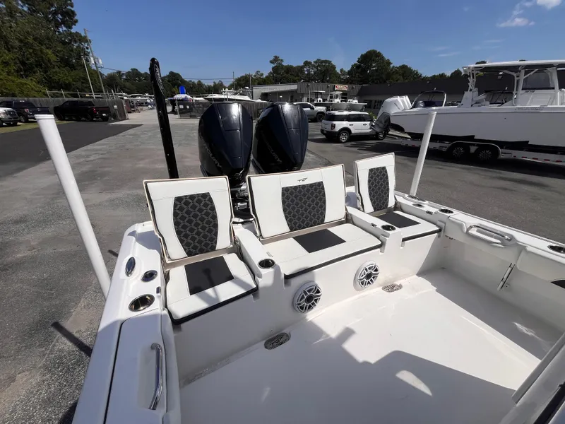 Slide: The Image of 2023 Tidewater 2700 Carolina Bay boat interior with seating and dual engines. - 6