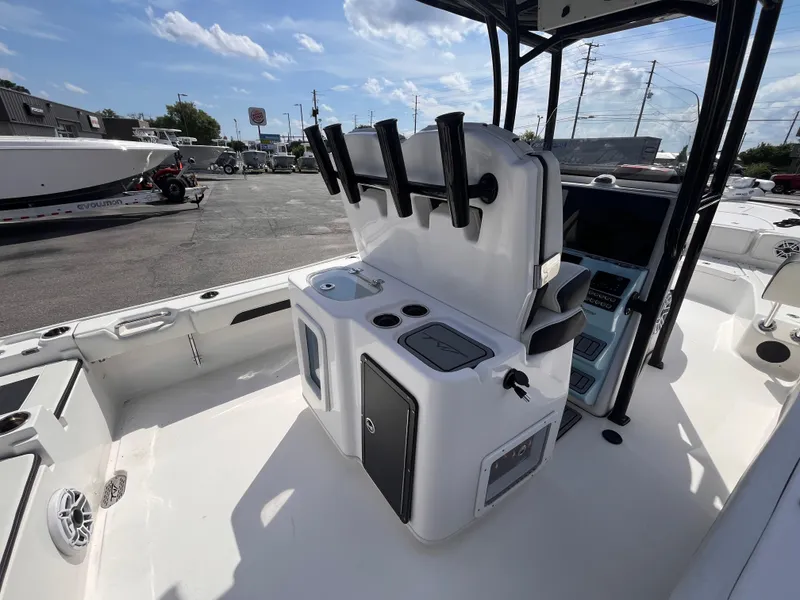 Slide: The Image of 2023 Tidewater 2700 Carolina Bay boat interior with console and rod holders. - 7