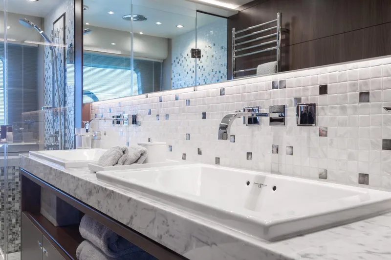 Slide: The Image of Luxurious bathroom in 2019 Princess Y88 Motor Yacht with elegant marble countertops and modern fixtures. - 16