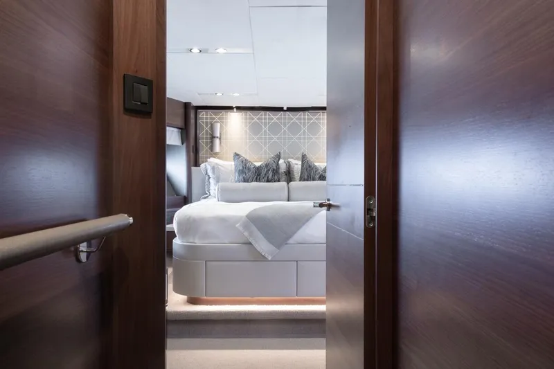 Slide: The Image of Luxurious bedroom interior on 2019 Princess Y88 Motor Yacht, featuring elegant bedding and modern design. - 18