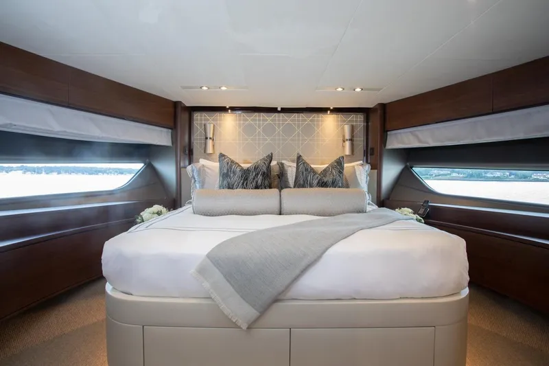 Slide: The Image of Luxurious bedroom interior of 2019 Princess Y88 Motor Yacht with elegant bedding and large windows. - 19