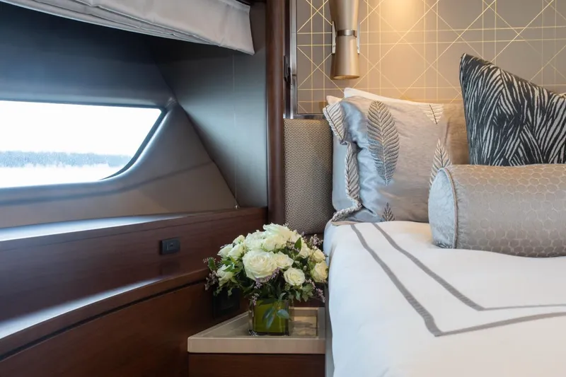 Slide: The Image of Luxurious bedroom interior of 2019 Princess Y88 Motor Yacht with elegant decor and floral arrangement. - 21