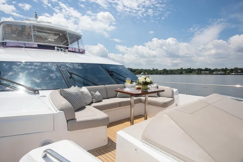 Slide: The Image of Luxurious 2019 Princess Y88 Motor Yacht deck with seating, table, and scenic water view. - 32