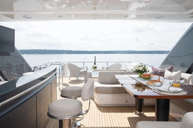 Slide: The Image of Luxurious 2019 Princess Y88 Motor Yacht deck with elegant seating and dining area overlooking the water. - 36