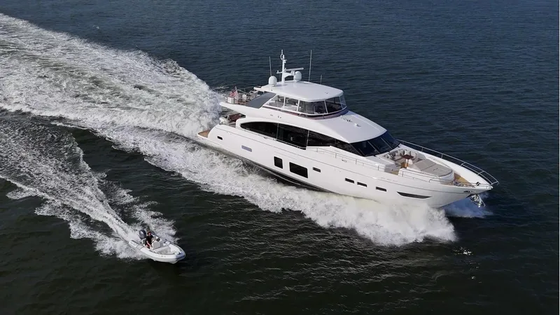Slide: The Image of 2019 Princess Y88 Motor Yacht cruising with a small boat on open water. - 41