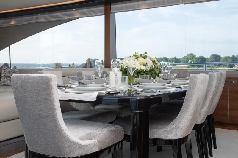 Slide: The Image of Luxurious dining area on 2019 Princess Y88 Motor Yacht with elegant table setting. - 6