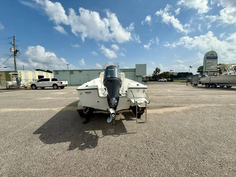 Slide: The Image of 2007 Sea Hunt Triton 172 boat in parking lot under blue sky. - 3