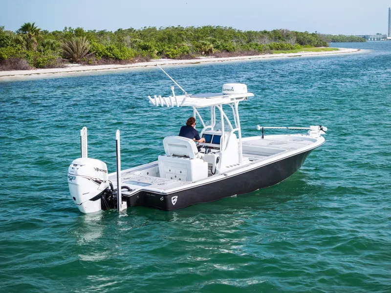 The Image of 2018 Barker Boatworks 26 Calibogue Bay cruising on clear blue water near a lush shoreline. - 0