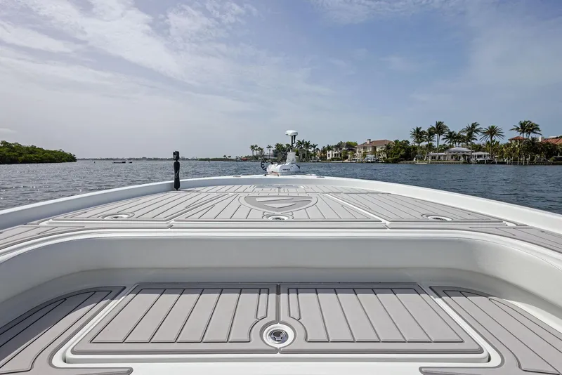 Slide: The Image of 2018 Barker Boatworks 26 Calibogue Bay on calm water, showcasing spacious deck and scenic view. - 13