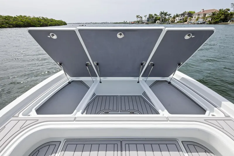 Slide: The Image of 2018 Barker Boatworks 26 Calibogue Bay with open storage compartments on calm water. - 15