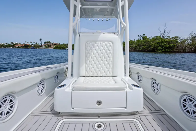Slide: The Image of 2018 Barker Boatworks 26 Calibogue Bay interior with white seating and speaker system. - 20
