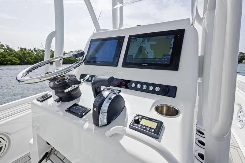 Slide: The Image of 2018 Barker Boatworks 26 Calibogue Bay helm with dual screens and controls. - 23