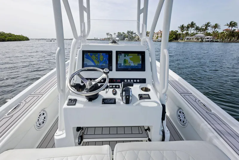 Slide: The Image of 2018 Barker Boatworks 26 Calibogue Bay console with dual navigation screens on calm water. - 25