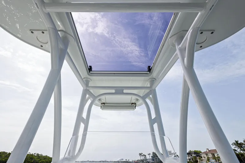 Slide: The Image of 2018 Barker Boatworks 26 Calibogue Bay, view of T-top and sky through glass roof. - 28