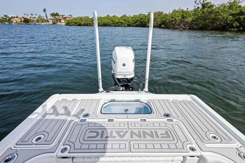 Slide: The Image of 2018 Barker Boatworks 26 Calibogue Bay on water, featuring motor and deck view. - 35