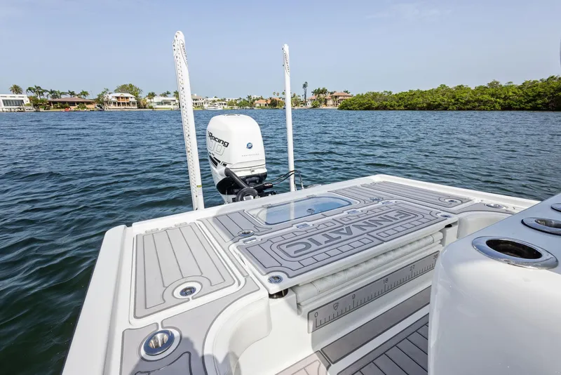 Slide: The Image of 2018 Barker Boatworks 26 Calibogue Bay on water, featuring deck and motor. - 37