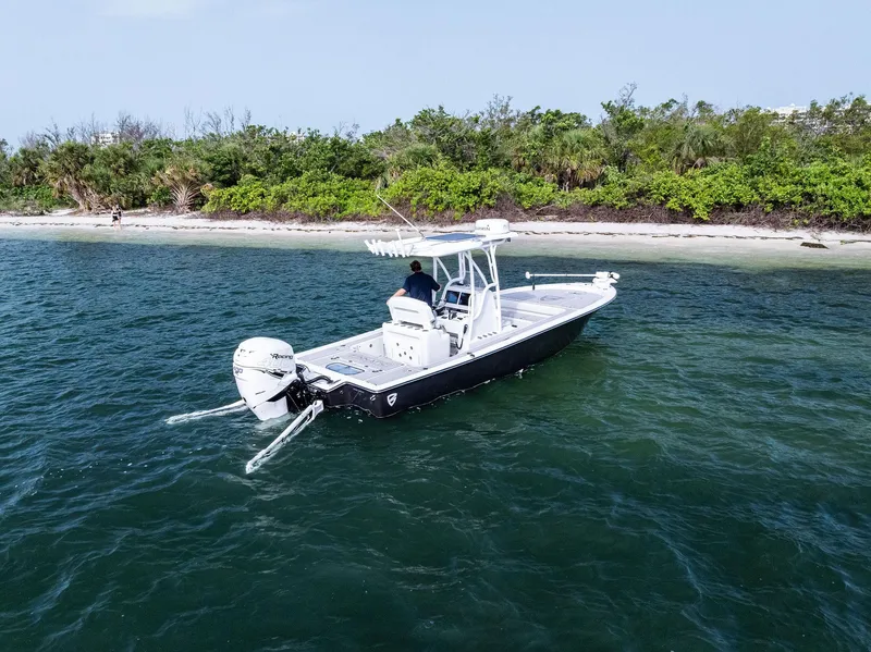 Slide: The Image of 2018 Barker Boatworks 26 Calibogue Bay on water near lush shoreline. - 6