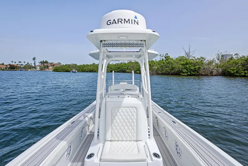Slide: The Image of 2018 Barker Boatworks 26 Calibogue Bay on water, featuring Garmin equipment, surrounded by scenic greenery. - 21