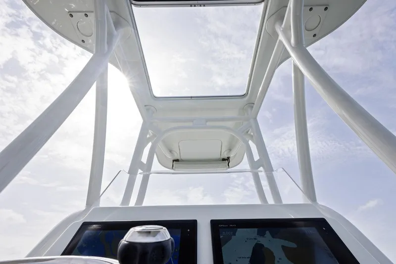 Slide: The Image of 2018 Barker Boatworks 26 Calibogue Bay helm with navigation screens and open sky view. - 29