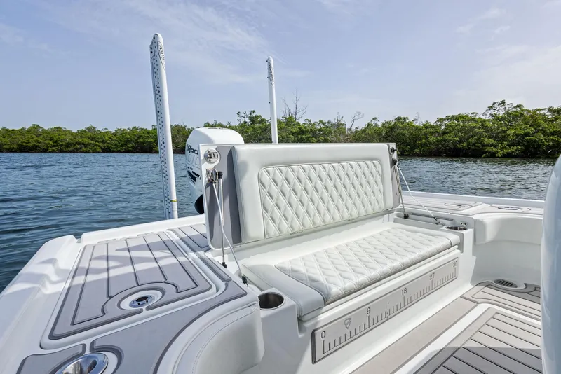 Slide: The Image of 2018 Barker Boatworks 26 Calibogue Bay with luxurious seating, on a serene water backdrop. - 32