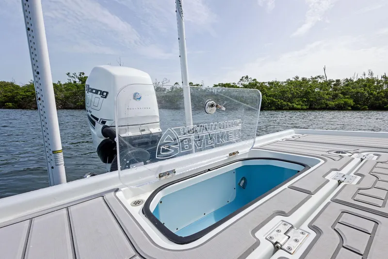Slide: The Image of 2018 Barker Boatworks 26 Calibogue Bay with open hatch and outboard motor on water. - 36