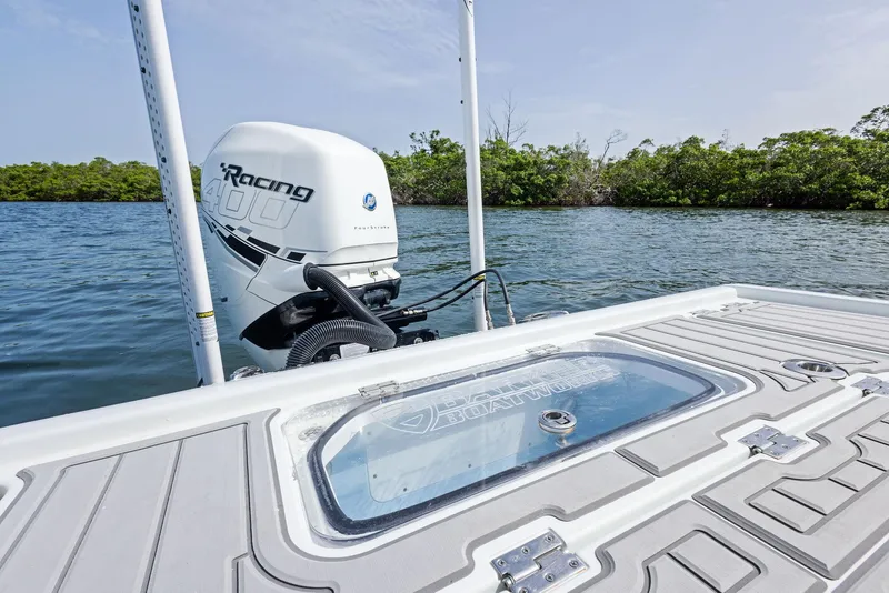 Slide: The Image of 2018 Barker Boatworks 26 Calibogue Bay with powerful outboard motor on calm water. - 38