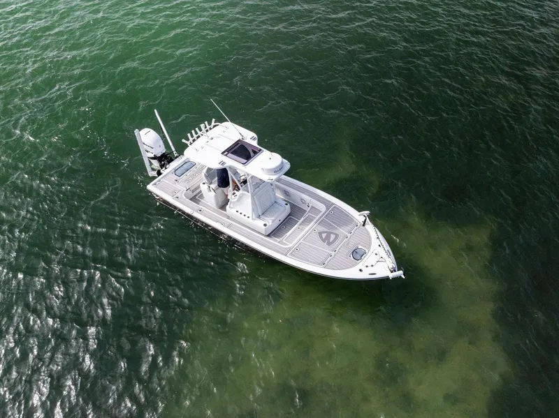 Slide: The Image of 2018 Barker Boatworks 26 Calibogue Bay on calm green water, aerial view. - 4