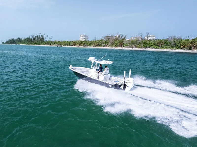 Slide: The Image of 2018 Barker Boatworks 26 Calibogue Bay cruising on open water near a lush shoreline. - 44