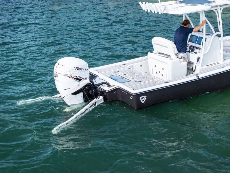 Slide: The Image of 2018 Barker Boatworks 26 Calibogue Bay on water, featuring powerful outboard engine. - 7