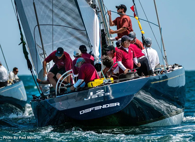 Slide: The Image of Crew sailing 1982 12 Meter sailboat "Defender" on open water. - 2