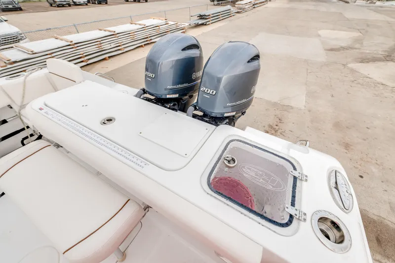 Slide: The Image of 2022 Sea Hunt Gamefish 27CE boat with dual Yamaha engines, rear view. - 14
