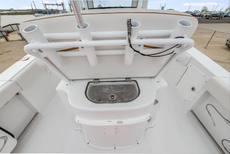 Slide: The Image of 2022 Sea Hunt Gamefish 27CE boat deck with rod holders and storage compartment. - 15