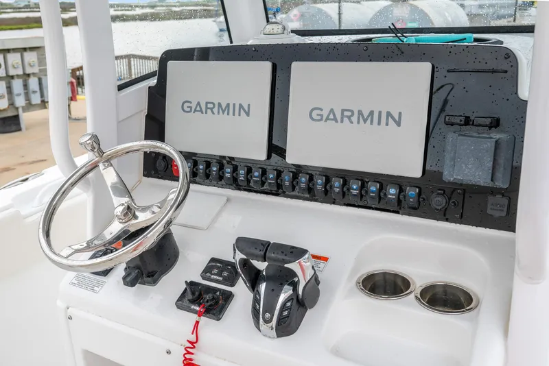 Slide: The Image of 2022 Sea Hunt Gamefish 27CE dashboard with dual Garmin displays and controls. - 18