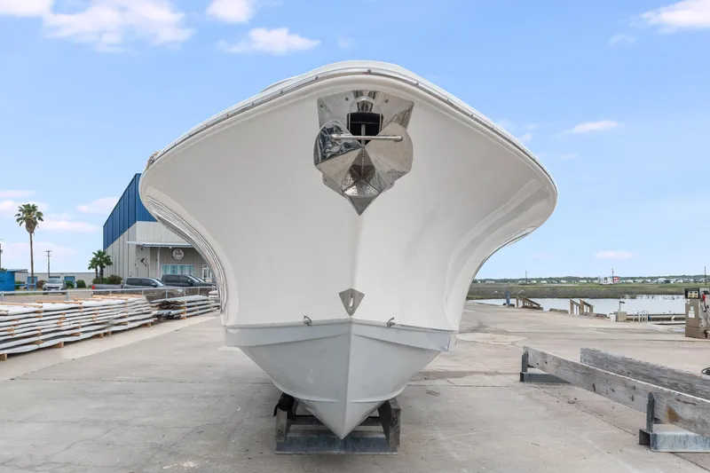 Slide: The Image of 2022 Sea Hunt Gamefish 27CE boat on dock, front view, clear sky background. - 2