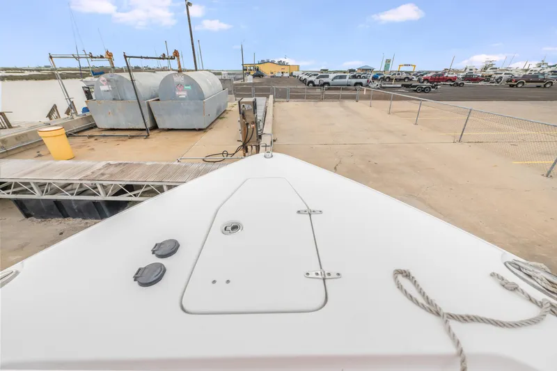 Slide: The Image of Bow view of 2022 Sea Hunt Gamefish 27CE at a dockside fuel station. - 20