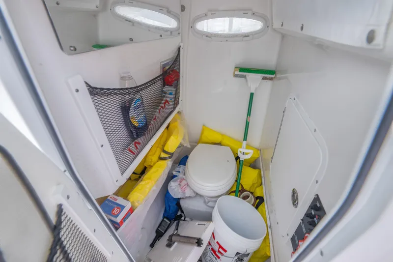 Slide: The Image of 2022 Sea Hunt Gamefish 27CE boat interior storage with toilet and cleaning supplies. - 21