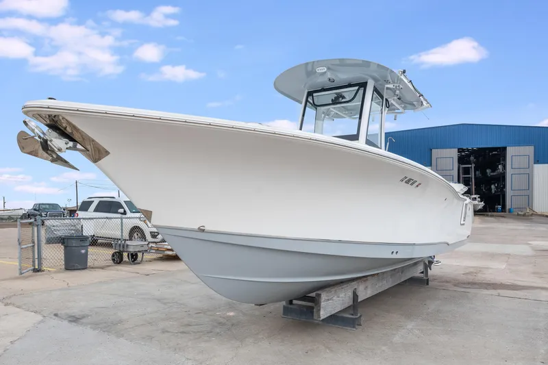 Slide: The Image of 2022 Sea Hunt Gamefish 27CE boat on display at a marina. - 3
