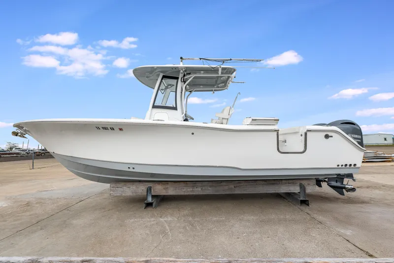 Slide: The Image of 2022 Sea Hunt Gamefish 27CE boat on display, side view, clear sky background. - 4