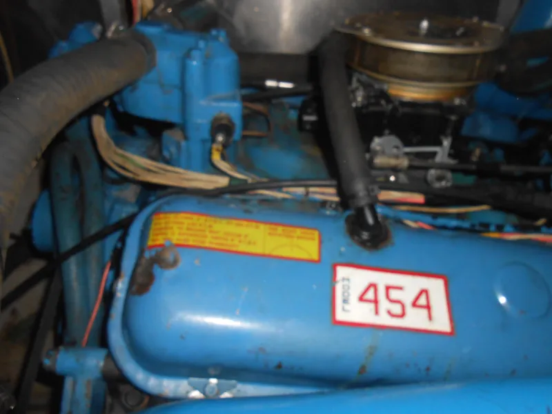 Slide: The Image of 1981 Uniflite Cabin Cruiser engine, blue with "454" label, showing hoses and components. - 19