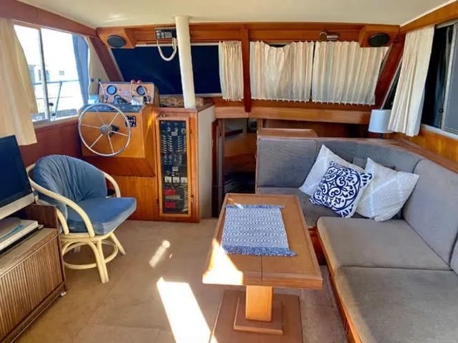 Slide: The Image of 1981 Uniflite Cabin Cruiser interior with cozy seating and nautical decor. - 37