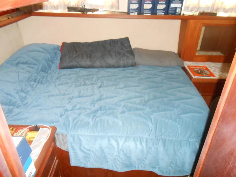 Slide: The Image of 1981 Uniflite Cabin Cruiser interior with cozy bed and wooden furnishings. - 6