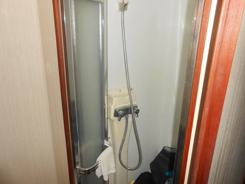 Slide: The Image of 1981 Uniflite Cabin Cruiser shower area with sliding door and handheld showerhead. - 8