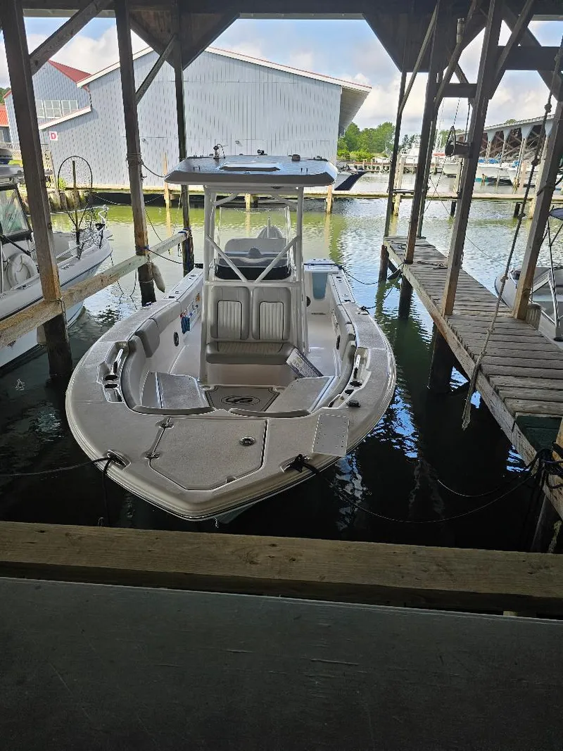 The Image of 2022 Sea Fox 248 Commander boat docked in a marina under a wooden shelter. - 0