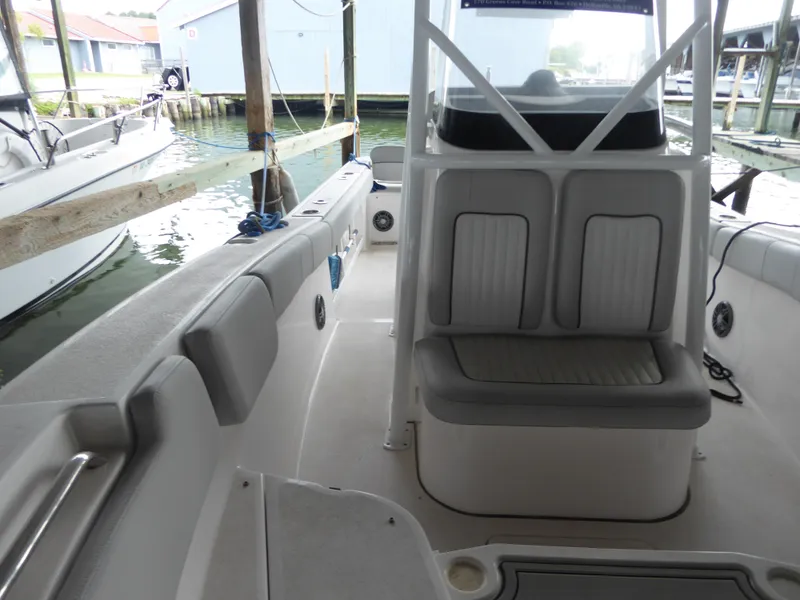 Slide: The Image of 2022 Sea Fox 248 Commander boat interior with seating and docked at marina. - 12