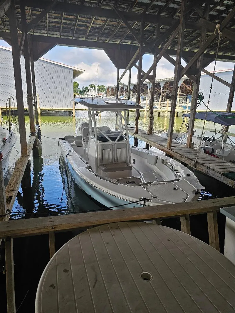 Slide: The Image of 2022 Sea Fox 248 Commander boat docked in a covered marina. - 2