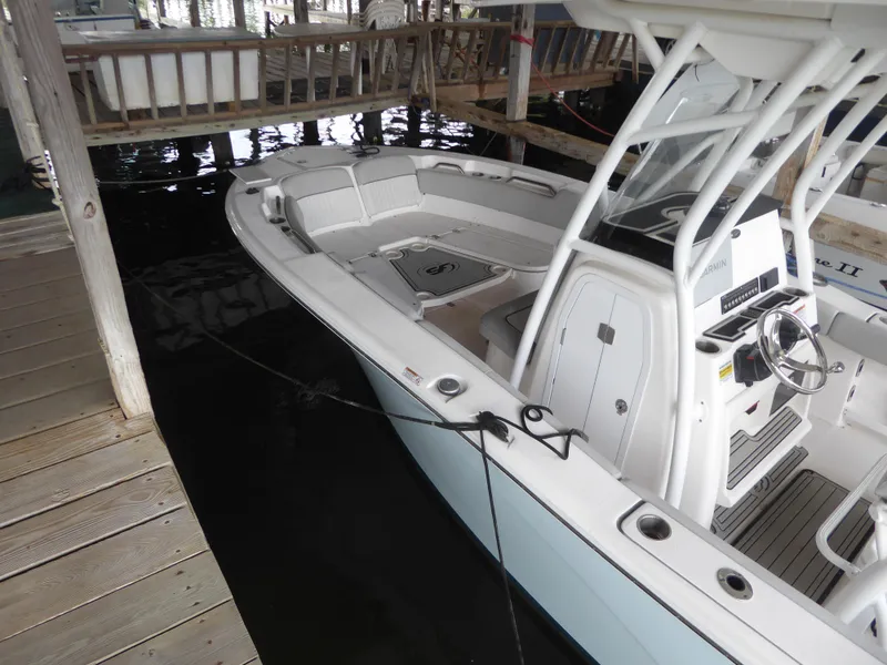 Slide: The Image of 2022 Sea Fox 248 Commander boat docked in a marina, showcasing sleek design and modern features. - 8